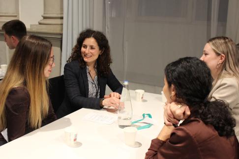 Internship students in business causal clothes at a networking event in Milan, Italy.