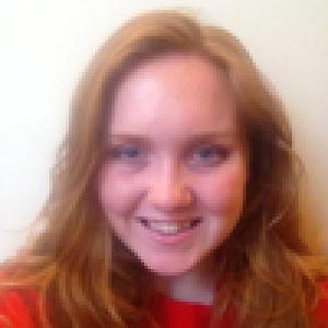 Smiling individuals in close-up portraits, indoors. This alt text was added with Al; accuracy may vary.