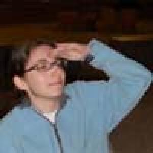 Person in a blue jacket, gazing upward with a hand on forehead. This alt text was added with Al; accuracy may vary.