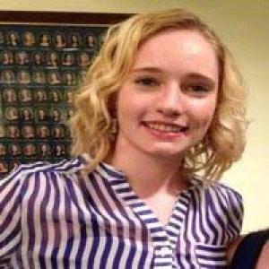 Smiling person in a blue shirt with a bright background.

Person with wavy blond hair and striped shirt, smiling indoors. This alt text was added with Al; accuracy may vary.