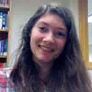 First image: Person in light blue jacket saluting.  
Second image: Smiling person with long hair in sunlight.  
Third image: Smiling person with long hair in a library. This alt text was added with Al; accuracy may vary.