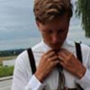 Five smiling people in individual close-up photos. This alt text was added with Al; accuracy may vary.