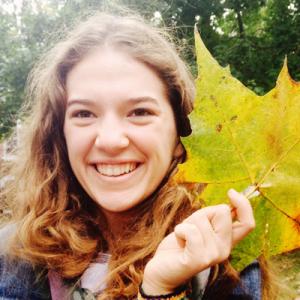 Portraits of four smiling individuals, one holding a large autumn leaf. This alt text was added with Al; accuracy may vary.
