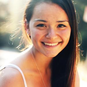 Sunset over city skyline with silhouetted rooftops. This alt text was added with Al; accuracy may vary.