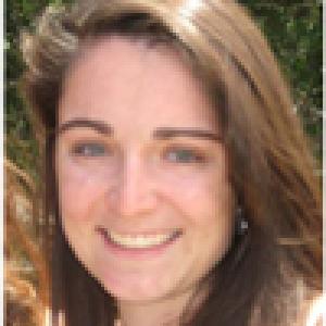 Four individual portrait photos of people, each smiling with different backgrounds. This alt text was added with Al; accuracy may vary.