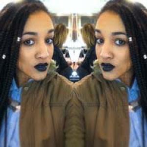 Smiling person in blue shirt with short hair, bright indoor setting. This alt text was added with Al; accuracy may vary.