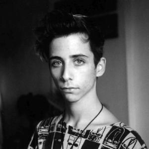 Young person with short hair in black and white portrait. This alt text was added with Al; accuracy may vary.