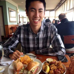 1. Smiling woman with long hair, in warm light, indoors.
2. Person in red jacket, gazing at ocean horizon.
3. Woman with curly hair, smiling against bright sky.
4. Smiling woman in outdoor setting during sunset.
5. Man smiling at a table with sandwiches and chips. This alt text was added with Al; accuracy may vary.