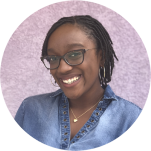 Phoenix Pittman smiling in front of pink background.