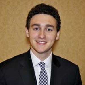 1. Woman with long brown hair, wearing glasses and a gray top.
2. Smiling woman with short hair and glasses.
3. Woman with glasses and curly hair, wearing a patterned top.
4. Smiling woman with medium-length hair, wearing a brown jacket outdoors.
5. Man in a suit with curly hair, smiling. This alt text was added with Al; accuracy may vary.