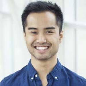 Smiling man in blue shirt, short hair, bright background. This alt text was added with Al; accuracy may vary.