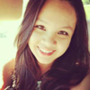 Smiling person in sunlight, close-up, with long hair. This alt text was added with Al; accuracy may vary.