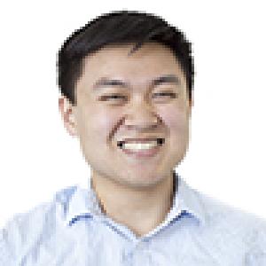 Man smiling in a white shirt against a white background. This alt text was added with Al; accuracy may vary.