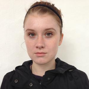 1. Woman smiling in library, long brown hair, lace top.
2. Woman smiling with scarf, outdoors by white flowers.
3. Man with short auburn hair, serious expression.
4. Woman with headband, serious face, neutral background. This alt text was added with Al; accuracy may vary.