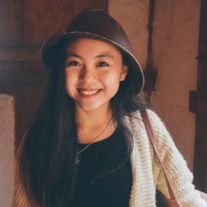 Person smiling indoors, wearing a hat and sweater. This alt text was added with Al; accuracy may vary.