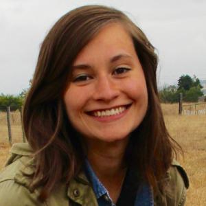 Black and white photo of a person with glasses and dark hair, looking at the camera. This alt text was added with Al; accuracy may vary.