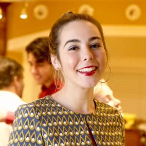 Sunset over city skyline with silhouetted rooftops and warm sky. This alt text was added with Al; accuracy may vary.