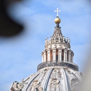 a cross atop a dome at the Vatican