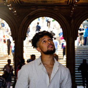 a headshot of Aiden looking up