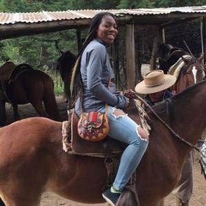 Malaysha White riding a brown horse