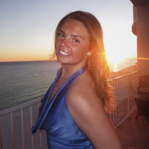 Makenna Watson sniling in front of the sunset.