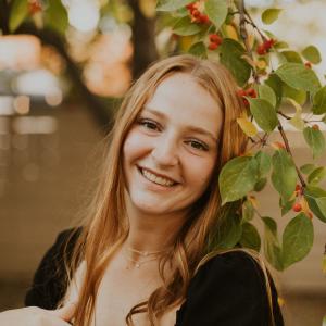 Alisha Latham smiling under tree