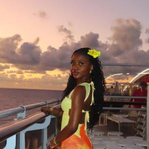 Grace Mazama posing in front of the sunset.