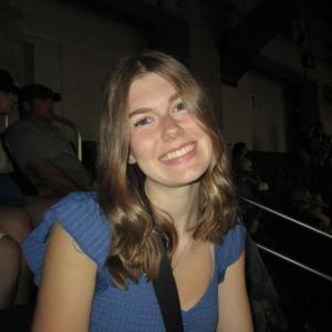 Julia Gerdes smiling in front of a black background.