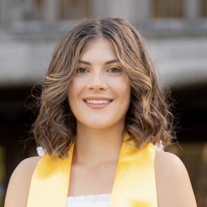Kendall Borchardt smiling in front a building.