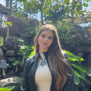 Lauren Poulin smiling in front of plants