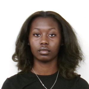 Melody Questelles posing in front of a white background.