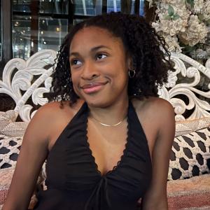 Chelsea Robinson smiling and looking off into the distance.