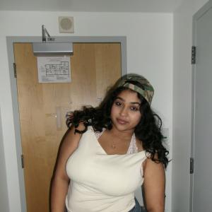 Dhyana Holla posing in front of a door. 