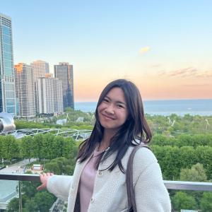 Eileen Li smiling in front of a skyline.