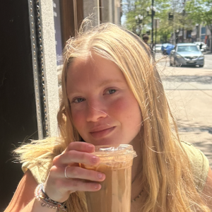 Hannah Grohman posing with a drink in her hands.