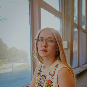Kat Loewe posing in front of a window.