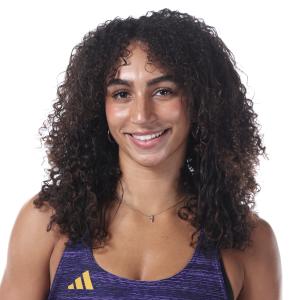 Mireya King smiling in front of a white background.