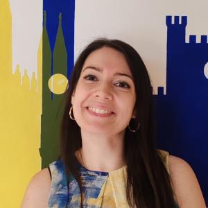 Italian Language Program Coordinator Antonella poses wearing  yellow shirt.