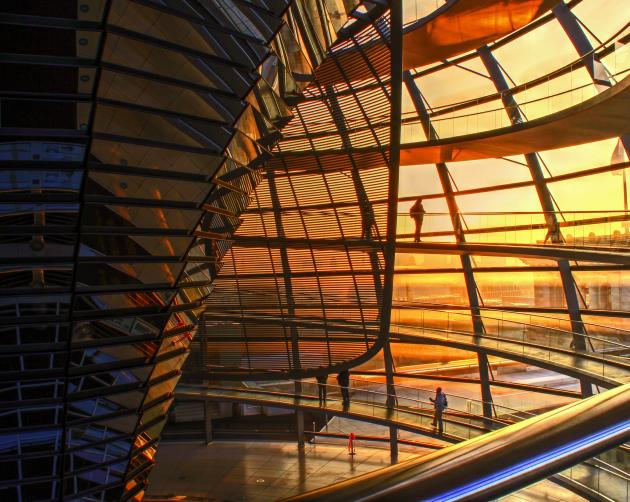 people walking in the dome atop the Reichstag building during sunset