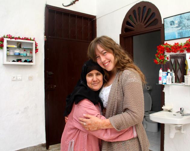 A student and their host mother hug in a Rabat homestay while smiling at the camera.