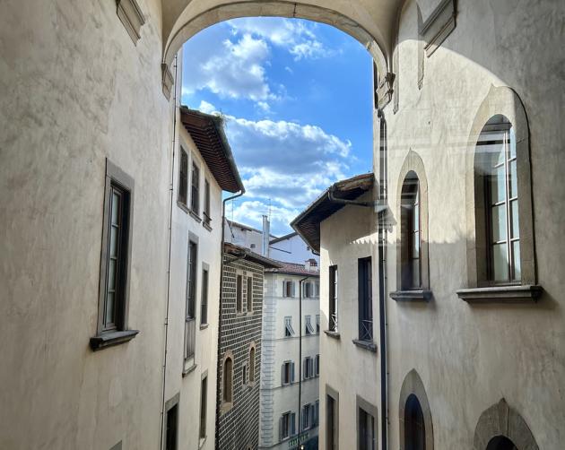 View of a Florence street through arches from above