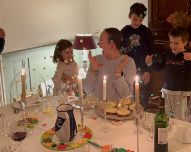 A student celebrating her birthday with her host family's kids at their home in Nantes
