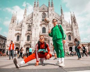 two students standing in front of a historical place in milan