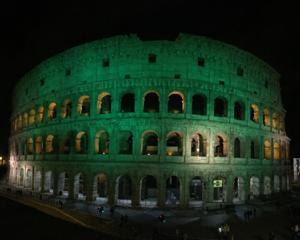 Colosseum lightened up in green colors in the evening 