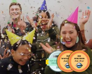 IES Abroad staff wearing party hats and throwing confetti with three award stamps over the photo