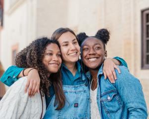 three students pose for a photo in the streets of Granada