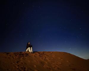 Student in the desert under the stars
