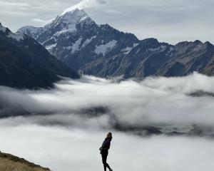 Student hiking amidst the clouds in Auckland