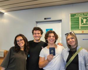 Students holding a passport in the hand 