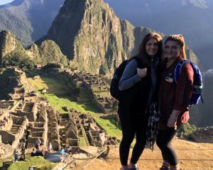 Audrey O’Donnell on a trip to Machu Picchu standing near the mountains hugging a woman 